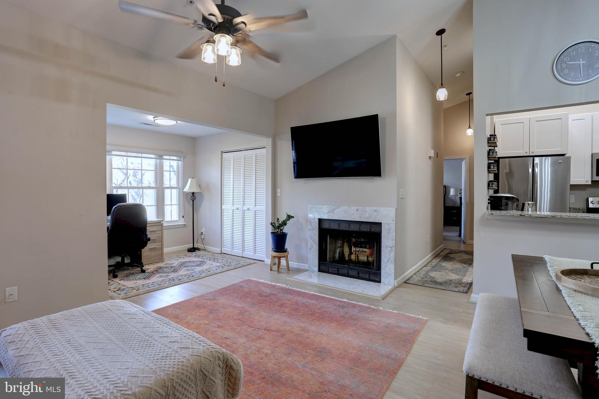 a spacious bedroom with a bed and a flat screen tv