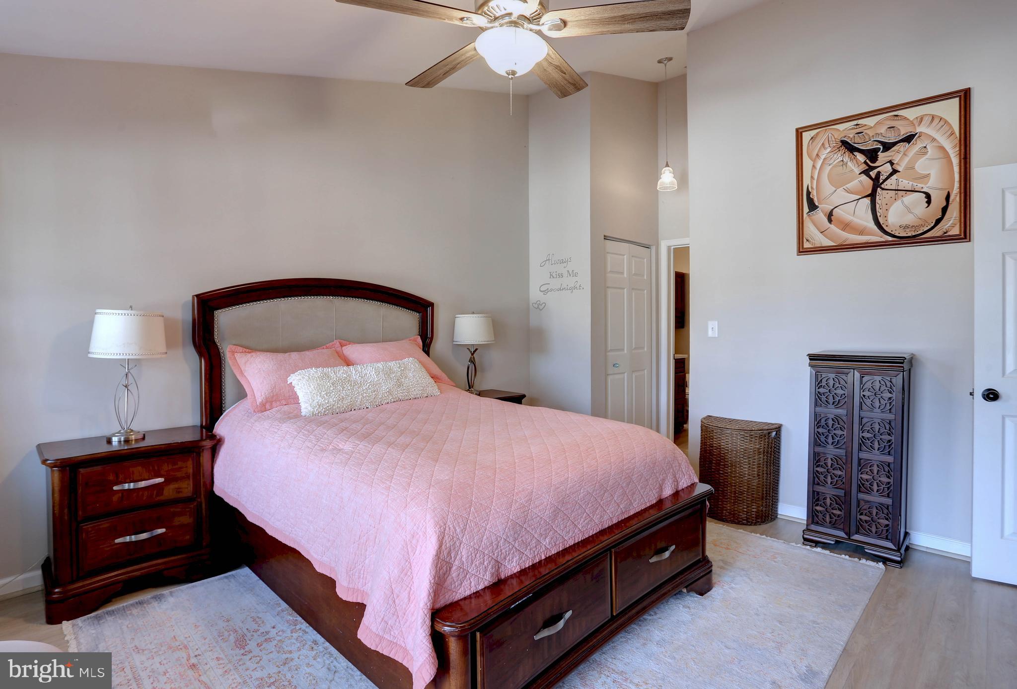 602 Moonglow Road, Unit 302 Odenton, MD 21113 - Photo 15 of 24 a bedroom with a bed and a lamp on dresser