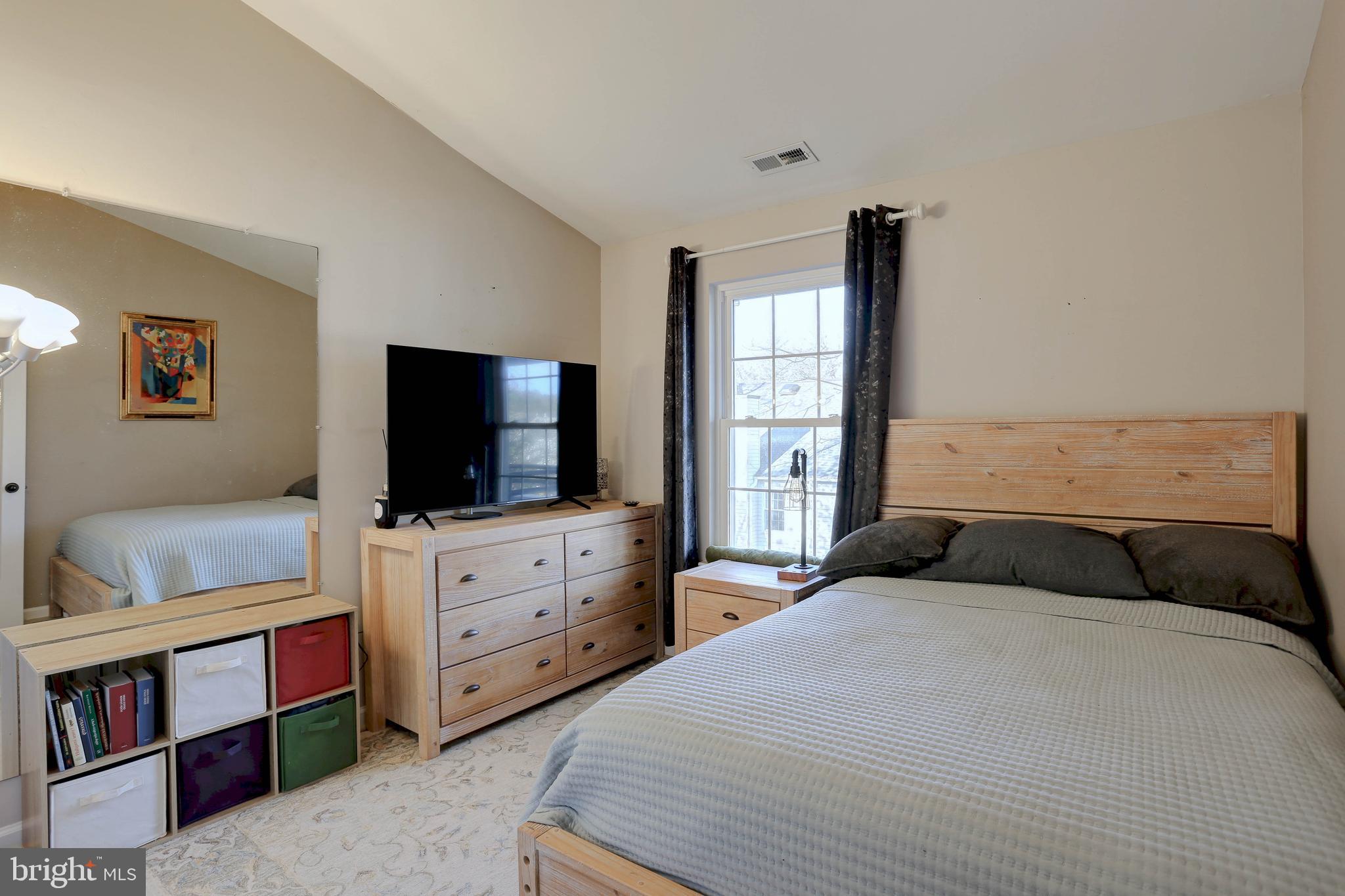 602 Moonglow Road, Unit 302 Odenton, MD 21113 - Photo 19 of 24 a bedroom with a bed and a flat screen tv