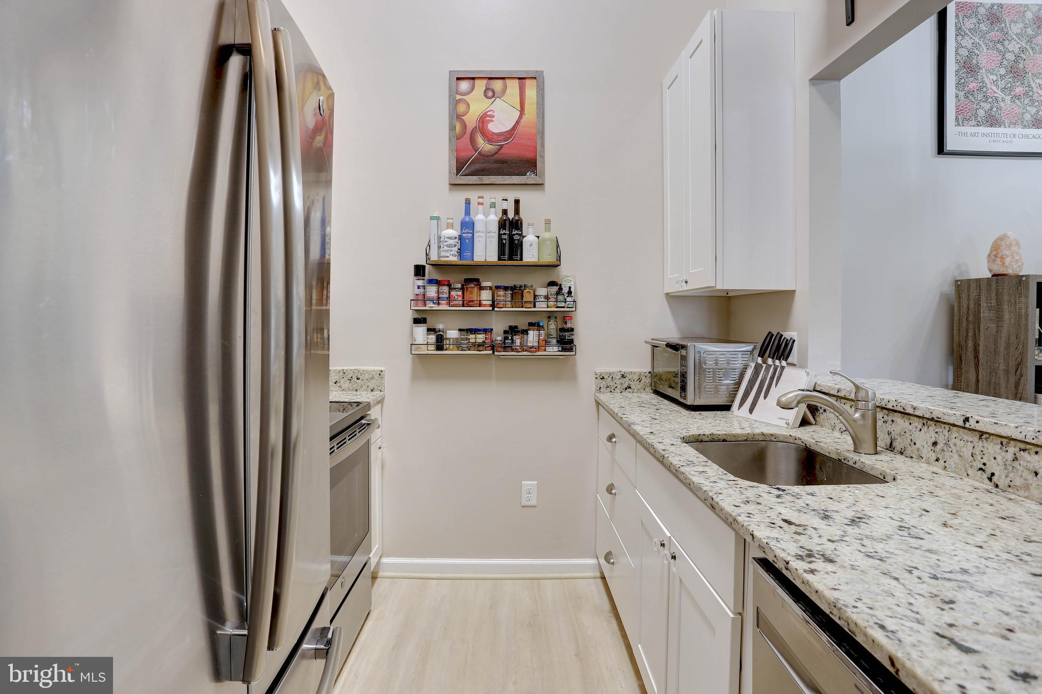 602 Moonglow Road, Unit 302 Odenton, MD 21113 - Photo 4 of 24 a kitchen with stainless steel appliances granite countertop a refrigerator and a sink