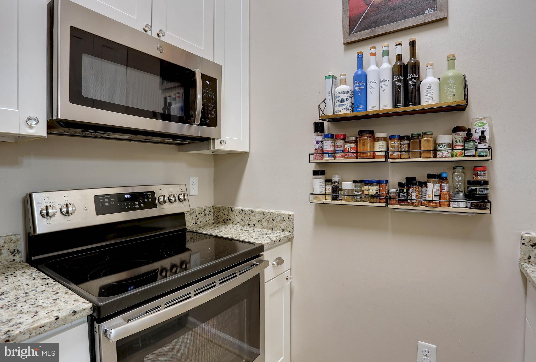 602 Moonglow Road, Unit 302 Odenton, MD 21113 - Photo 5 of 24 a kitchen with stainless steel appliances granite countertop a stove and a microwave
