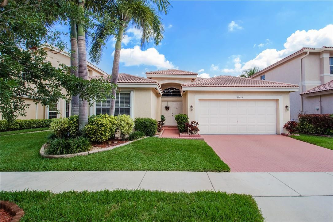 17445 Southwest 33rd Court Miramar, FL 33029 - Photo 1 of 23 a front view of a house with a garden and palm trees