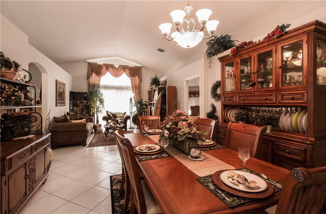 17445 Southwest 33rd Court Miramar, FL 33029 - Photo 2 of 23 a view of a dining room with furniture large window and chandelier
