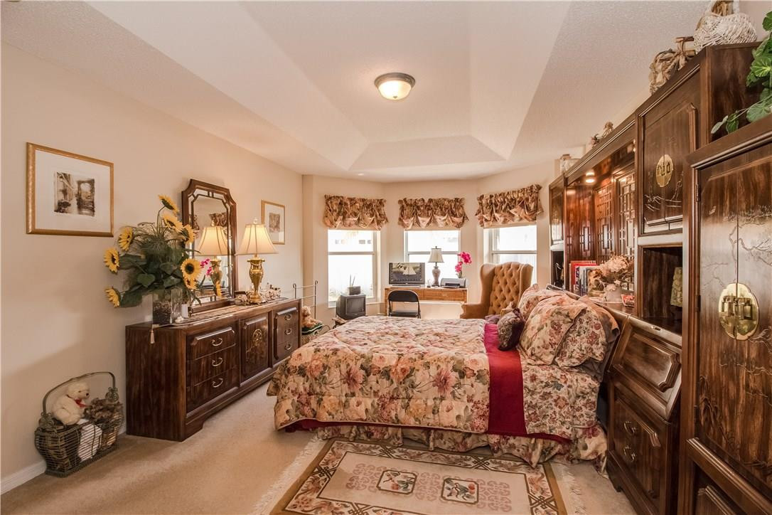 17445 Southwest 33rd Court Miramar, FL 33029 - Photo 4 of 23 a bedroom with a bed and a flat tv screen on the dresser