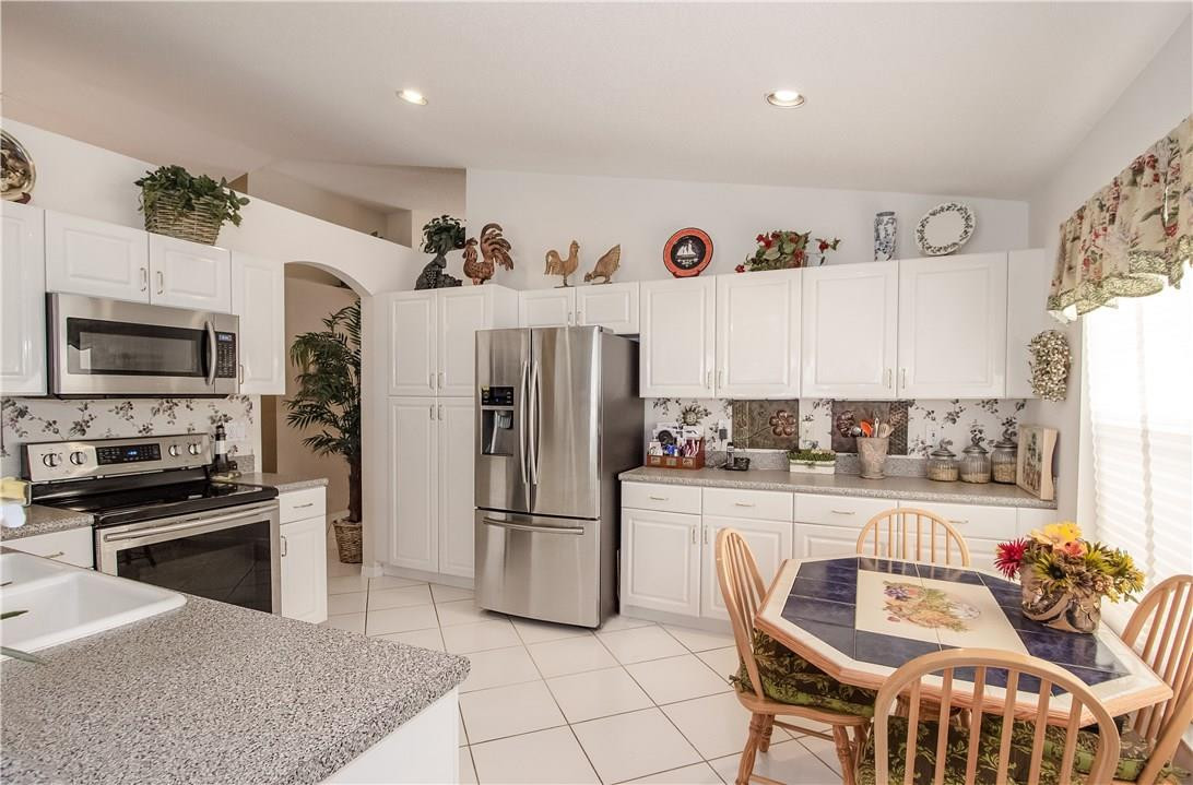 17445 Southwest 33rd Court Miramar, FL 33029 - Photo 8 of 23 a kitchen with stainless steel appliances granite countertop a refrigerator and microwave