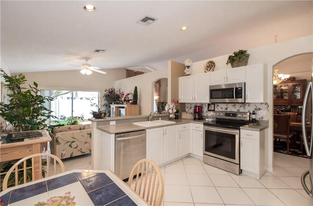 17445 Southwest 33rd Court Miramar, FL 33029 - Photo 10 of 23 a kitchen with stainless steel appliances a stove sink and microwave