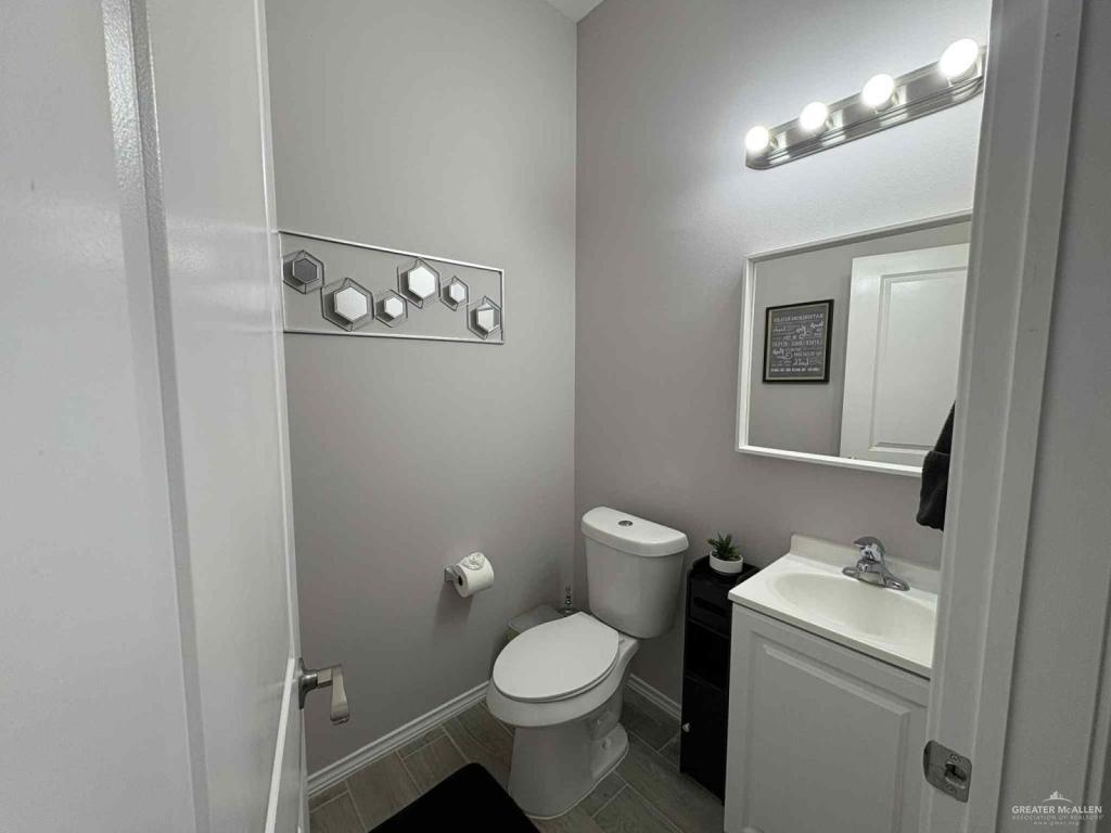 2007 Cassandra Street Mission, TX 78572 - Photo 7 of 10 a bathroom with a toilet sink and mirror