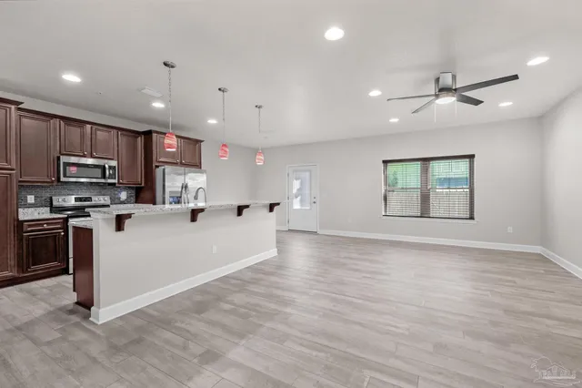 a view of kitchen with stainless steel appliances refrigerator oven and microwave