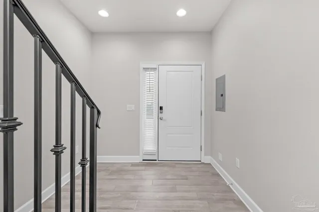 a view of an entryway with wooden floor