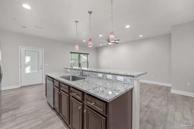 a kitchen with a counter space and wooden floor