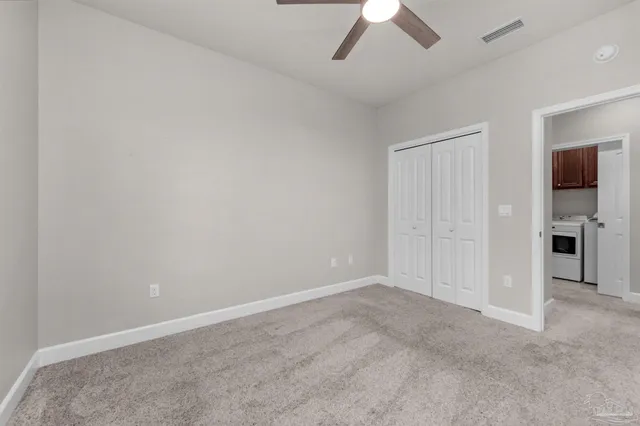 a utility room with cabinets washer and dryer