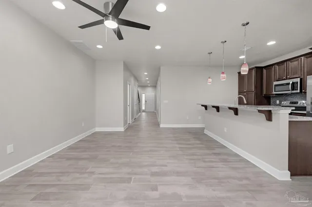 a view of kitchen with stainless steel appliances a refrigerator and a microwave