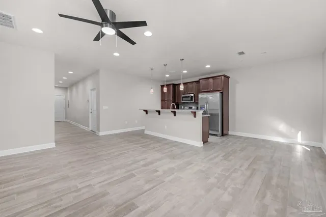 a view of a livingroom with furniture and ceiling fan