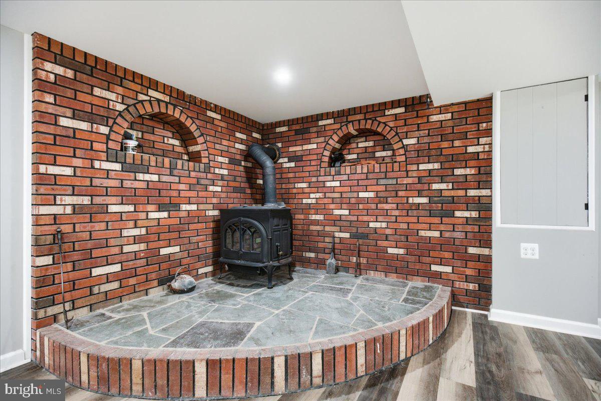 2175 Ponds Wood Road Huntingtown, MD 20639 - Photo 68 of 76 Brick corner with wood stove