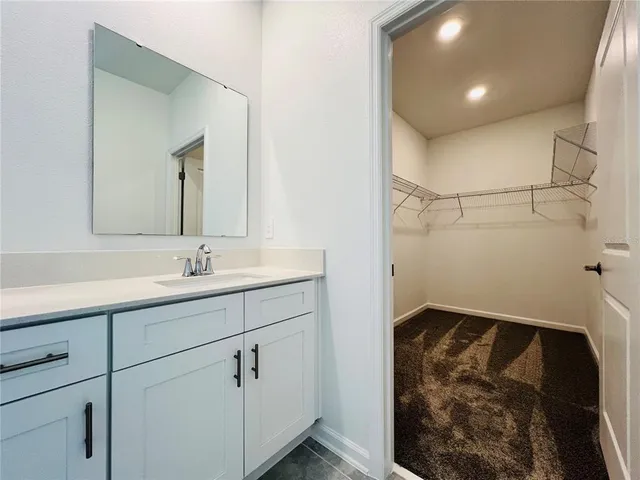 a bathroom with a sink and mirror
