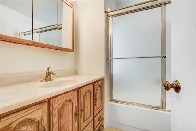 a bathroom with a shower and a sink