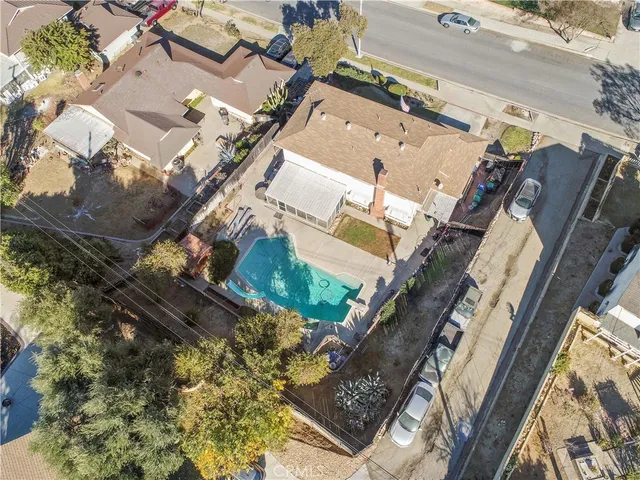 an aerial view of a house with a yard