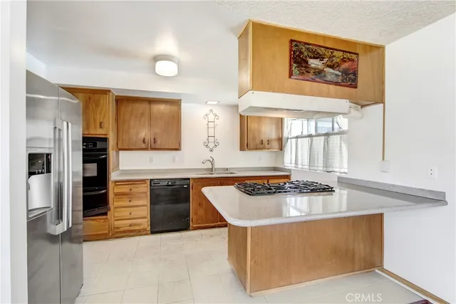 a kitchen with stainless steel appliances granite countertop a stove and a refrigerator