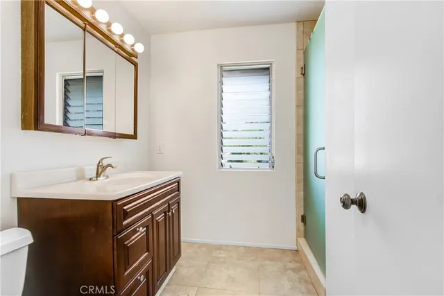 a bathroom with a sink a toilet and mirror