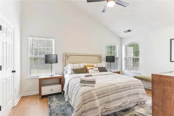 a bedroom with a bed and a chandelier