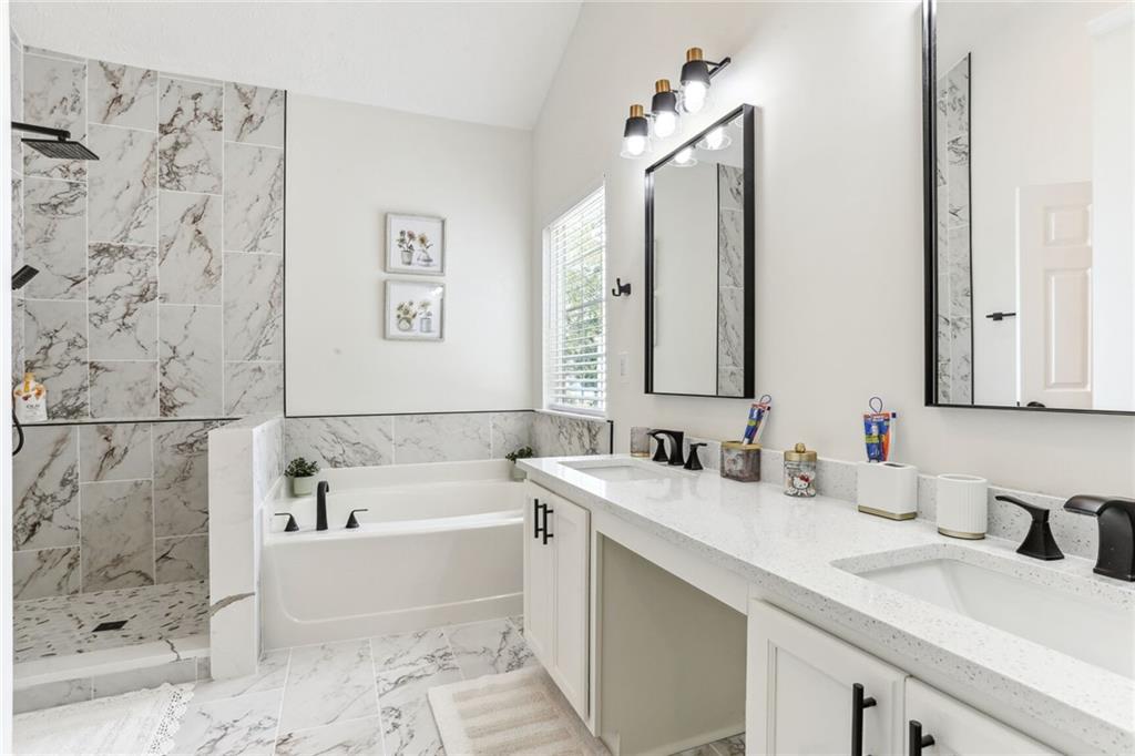 859 Springchase Drive Austell, GA 30168 - Photo 17 of 28 a bathroom with a tub sink and mirror