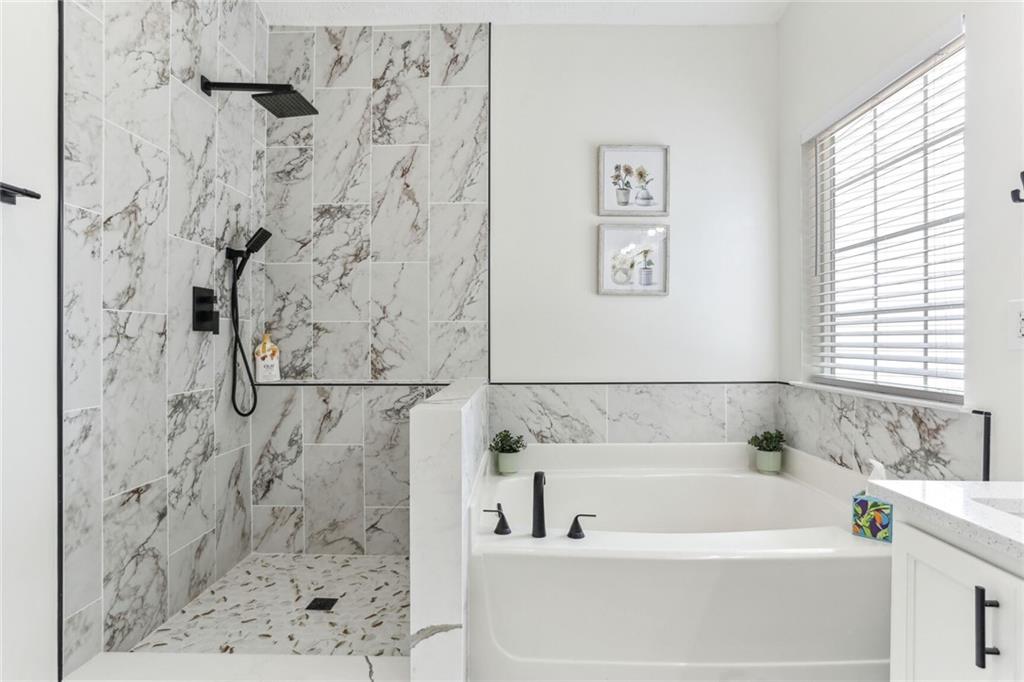 859 Springchase Drive Austell, GA 30168 - Photo 18 of 28 a bathroom with a shower and a bathtub