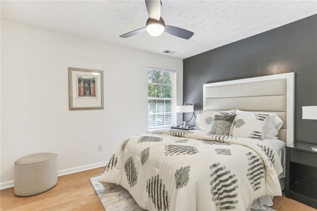 859 Springchase Drive Austell, GA 30168 - Photo 20 of 28 a bedroom with a bed and a painting on the wall