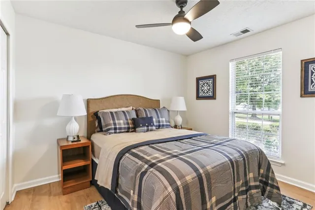 a bedroom with a bed and a large window