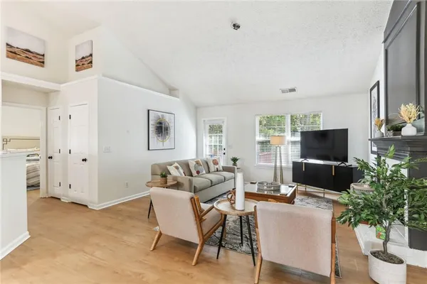 a living room with furniture and a flat screen tv