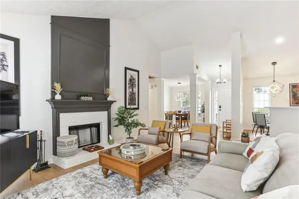 a living room with furniture a fireplace and a table