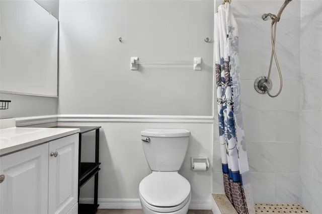 a bathroom with a toilet a sink and shower