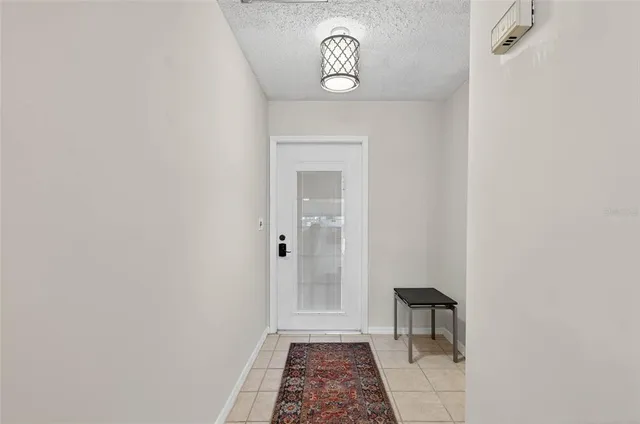 a view of a hallway with a door and a mirror