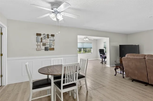a view of a dining room with furniture and wooden floor
