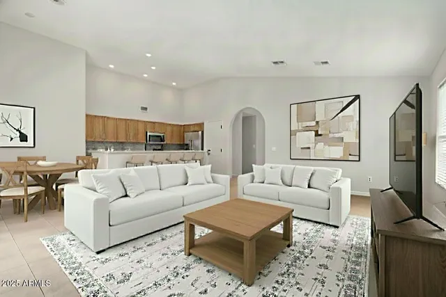 a living room with furniture a rug and a flat screen tv