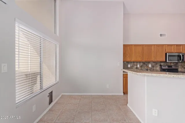 a view of a kitchen with a sink and a refrigerator