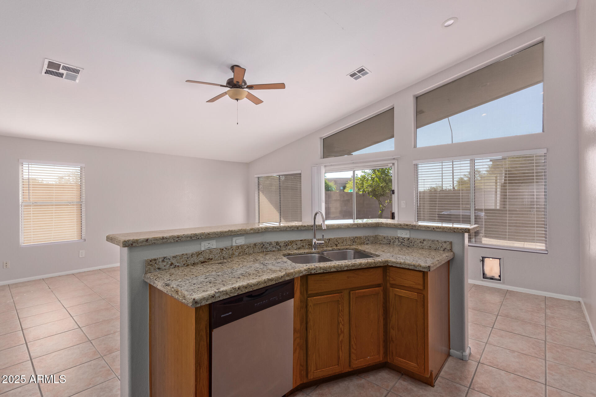 208 East Devon Drive Gilbert, AZ 85296 - Photo 11 of 37 a kitchen with a granite countertop sink and wooden floor