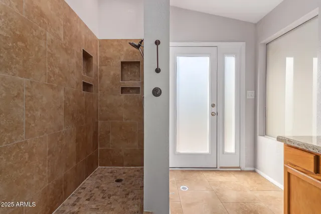 a bathroom with a granite countertop sink and a mirror