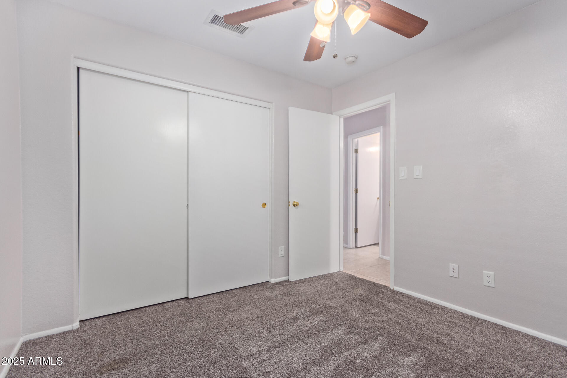 208 East Devon Drive Gilbert, AZ 85296 - Photo 22 of 37 an empty room with a chandelier fan