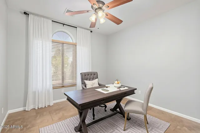 an empty room with a chandelier fan