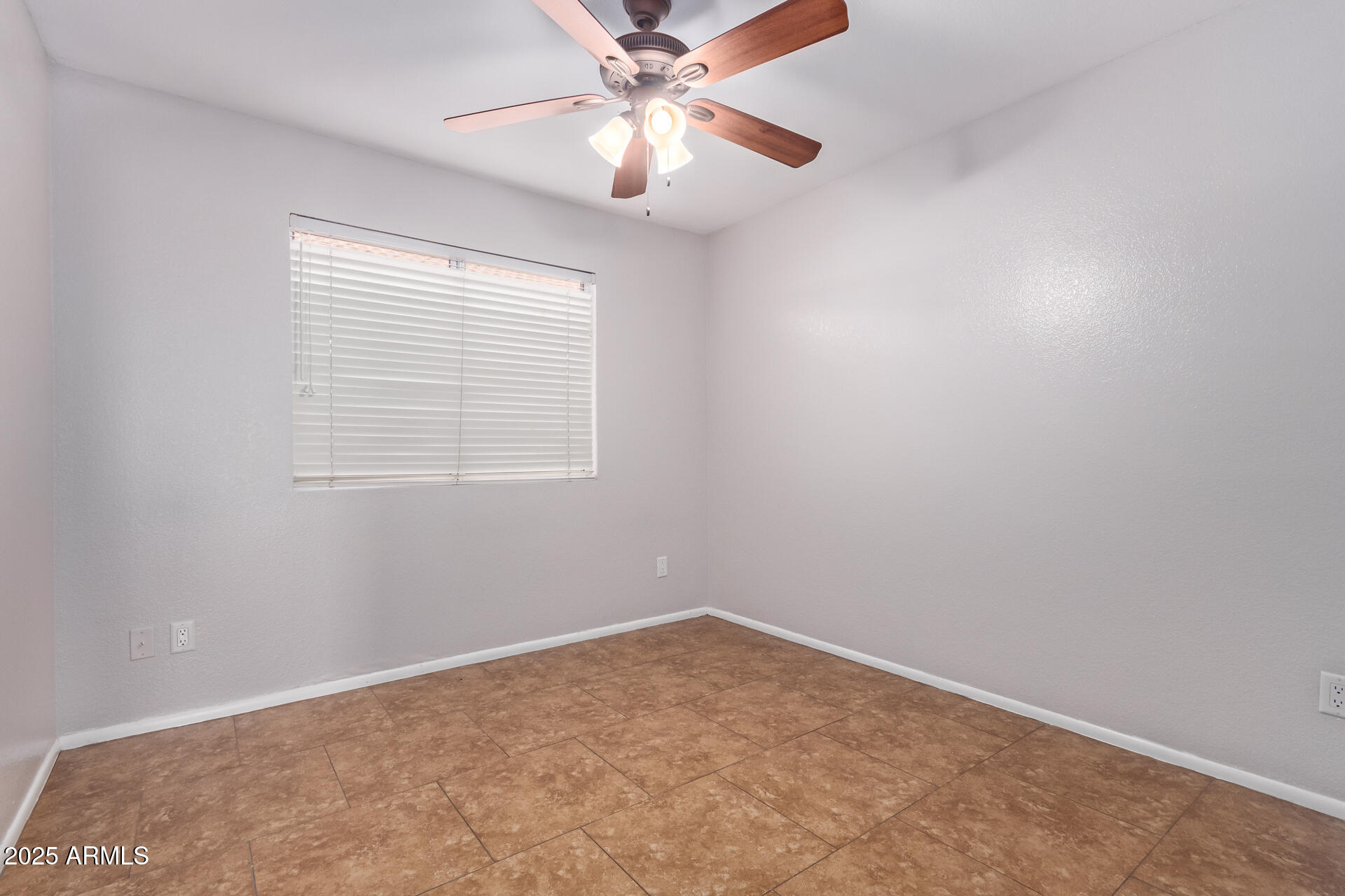 208 East Devon Drive Gilbert, AZ 85296 - Photo 27 of 37 an empty room with a window and a fan