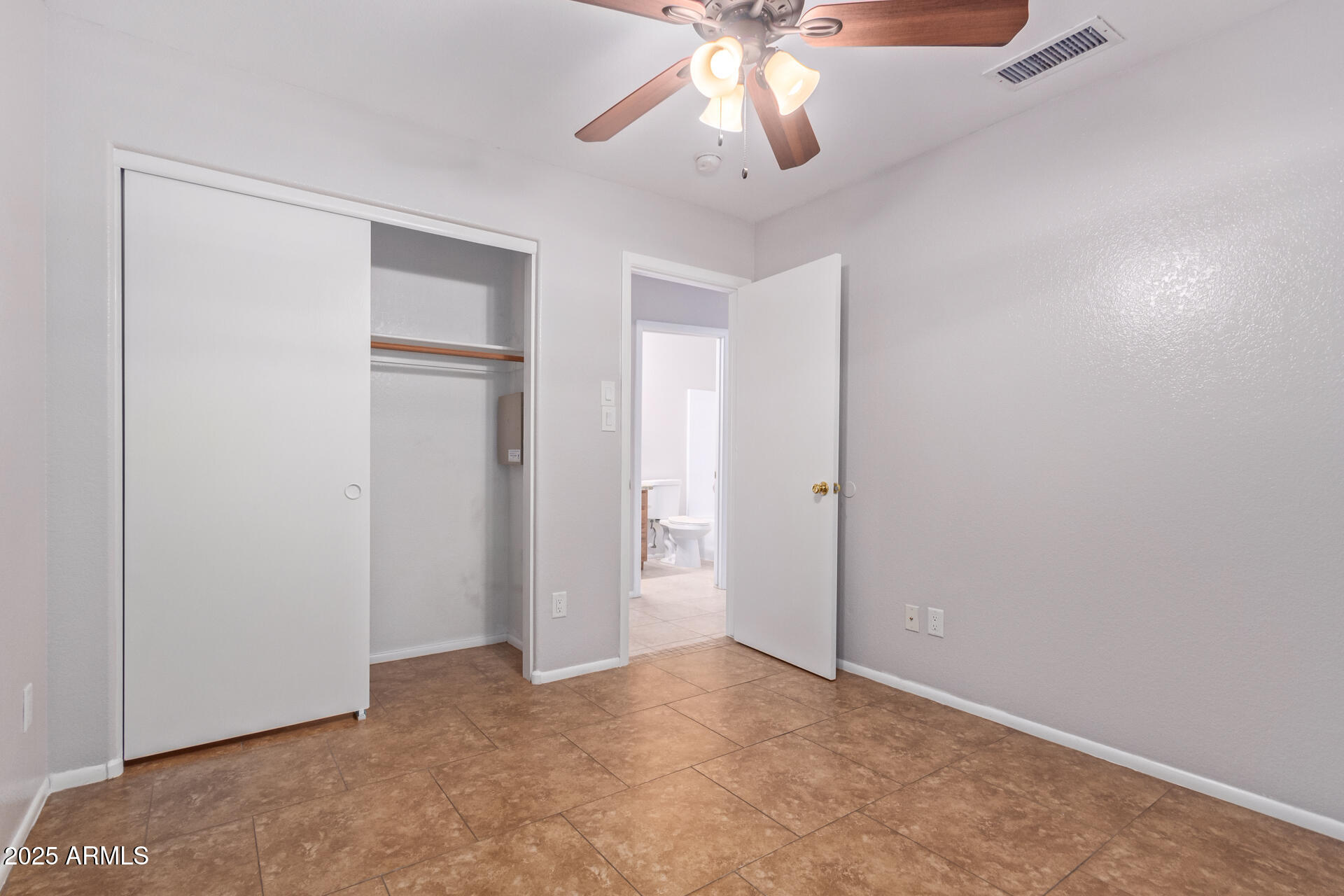 208 East Devon Drive Gilbert, AZ 85296 - Photo 28 of 37 an empty room with a empty space and a ceiling fan
