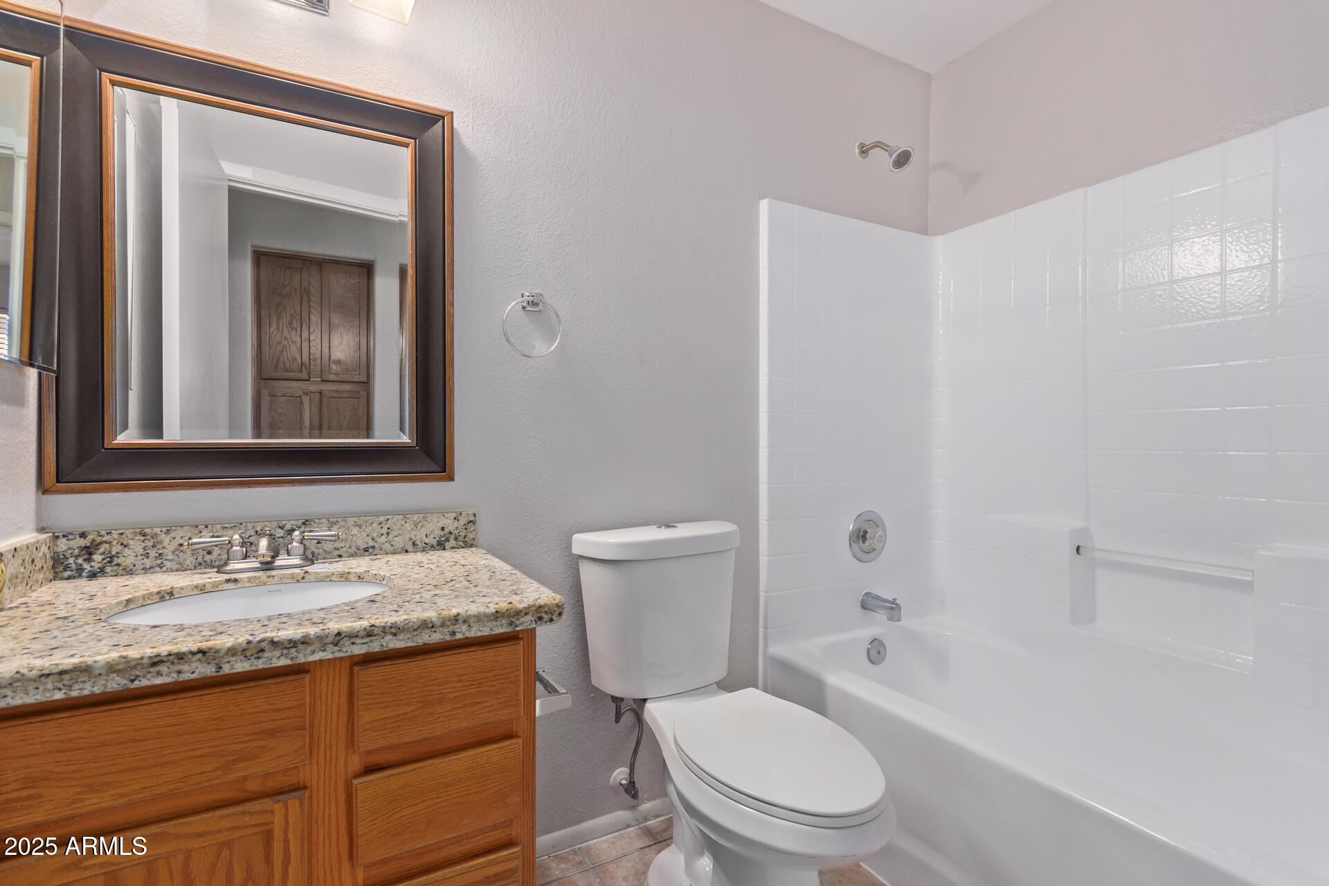 208 East Devon Drive Gilbert, AZ 85296 - Photo 29 of 37 a bathroom with a granite countertop toilet a sink and a mirror