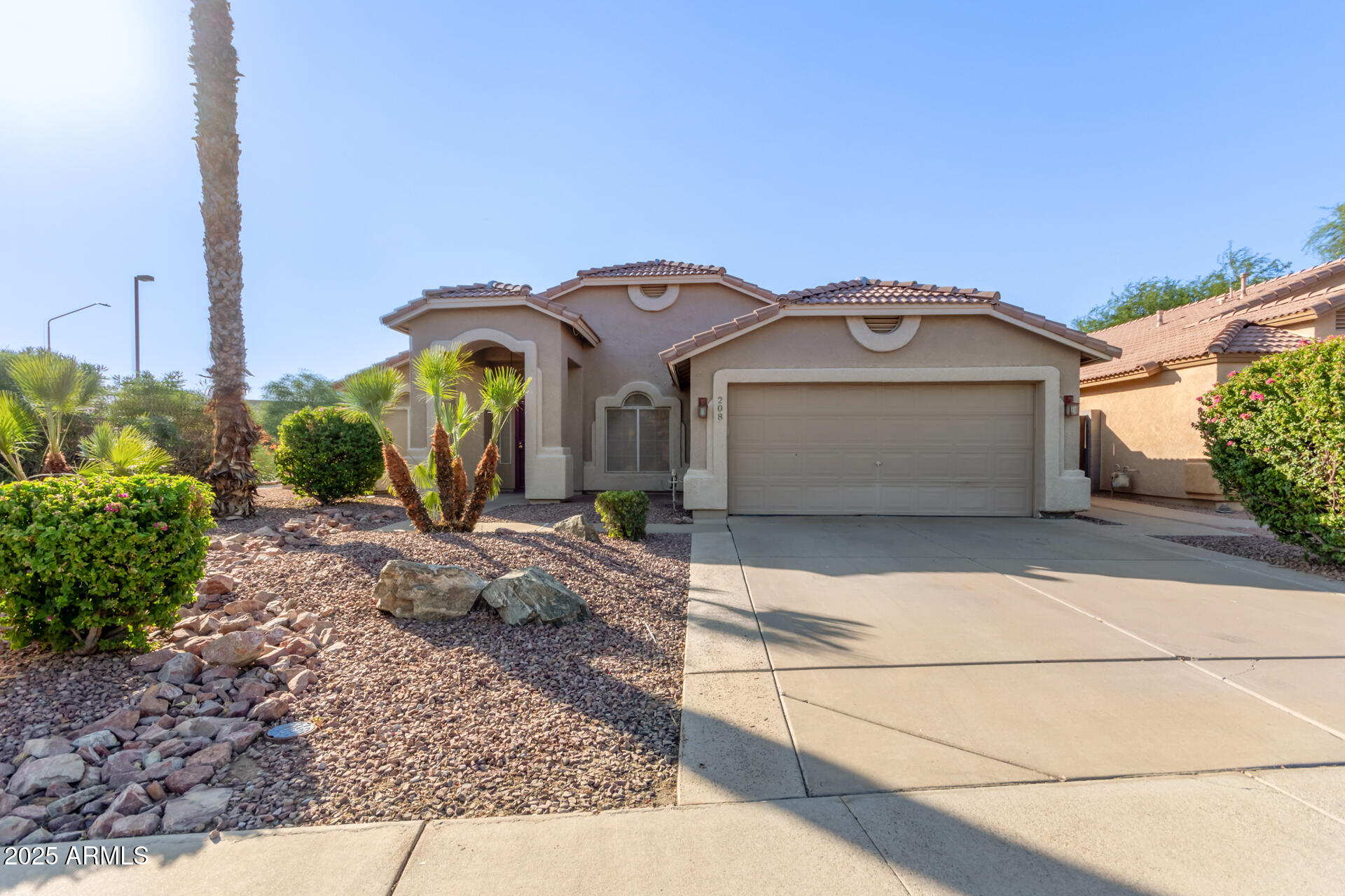 208 East Devon Drive Gilbert, AZ 85296 - Photo 2 of 37 a front view of a house with garden