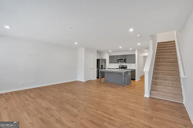 a view of kitchen with microwave and cabinets