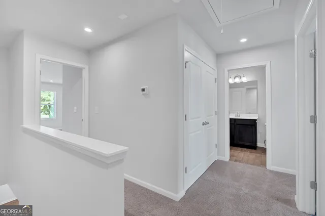 a view of a hallway with an entryway and livingroom