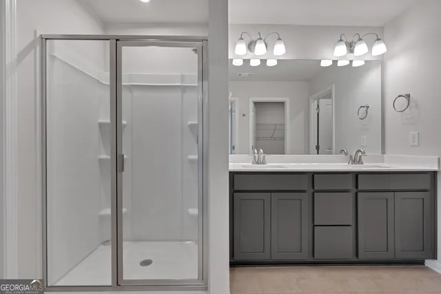 a bathroom with a double vanity sink and a mirror