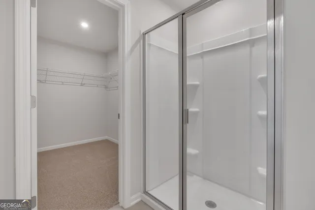 a bathroom with a glass shower door