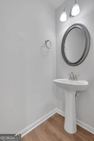 a bathroom with a sink mirror and toilet