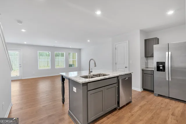 a kitchen with a sink and refrigerator