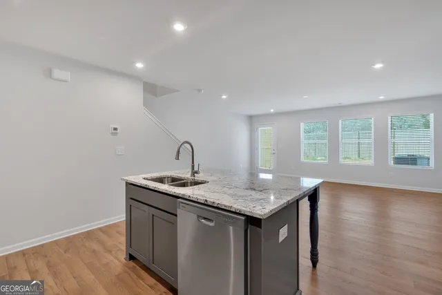 a kitchen with a sink a counter space and a window